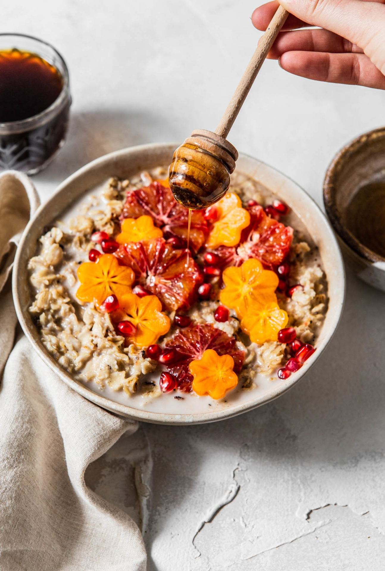 oatmeal bowl with honey drizzle and flower cut fruits photography