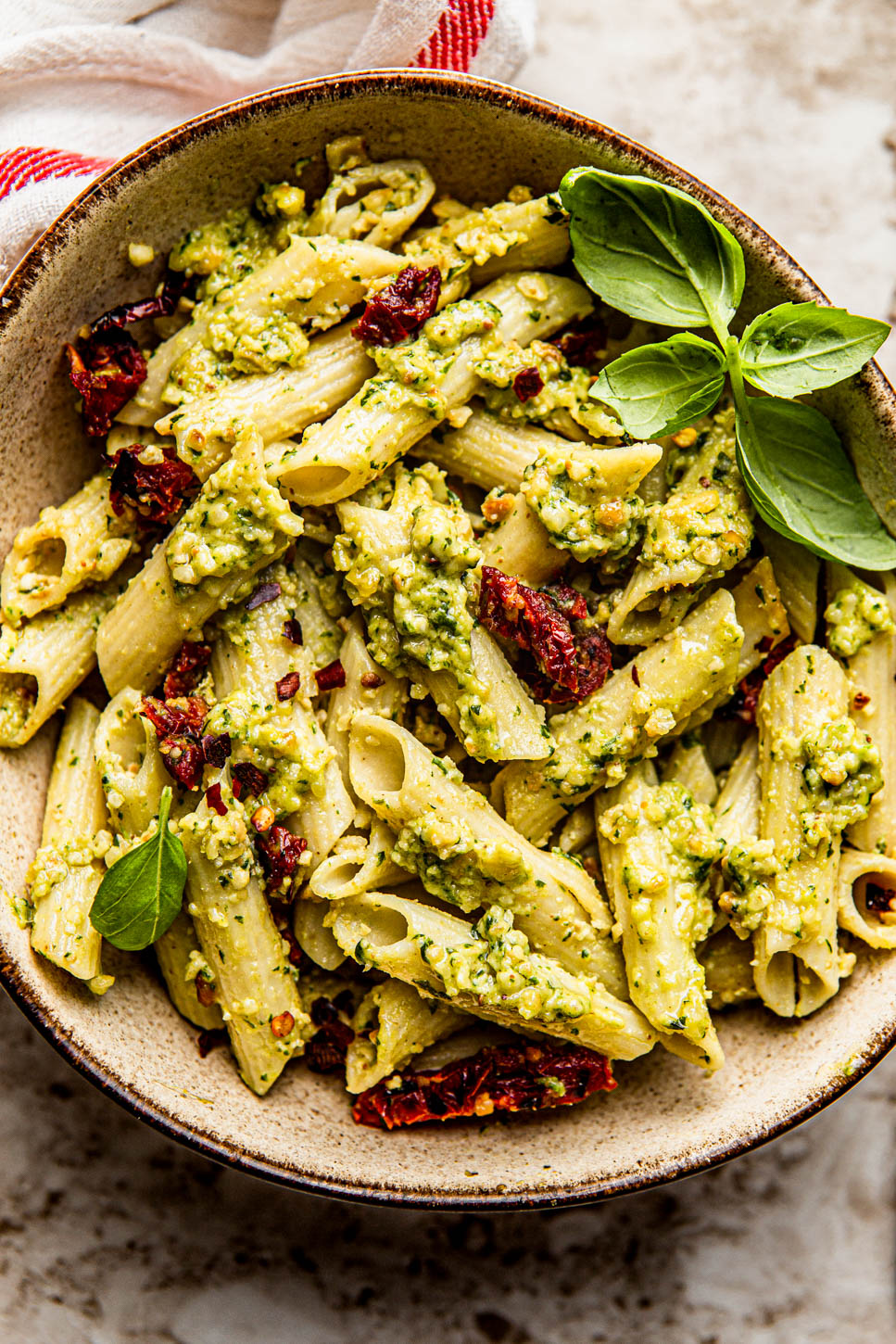 pesto pasta photography with sundried tomatoes an basil