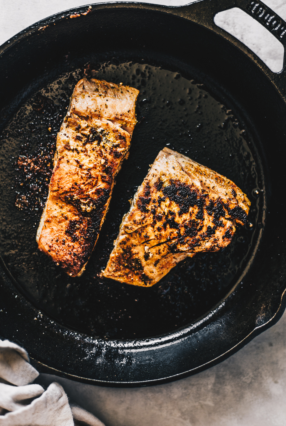 blackened seared salmon in cast iron skillet photography