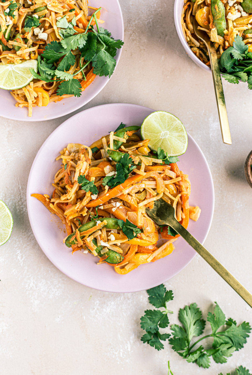 colorful vegetable pad thai with cilantro and lime