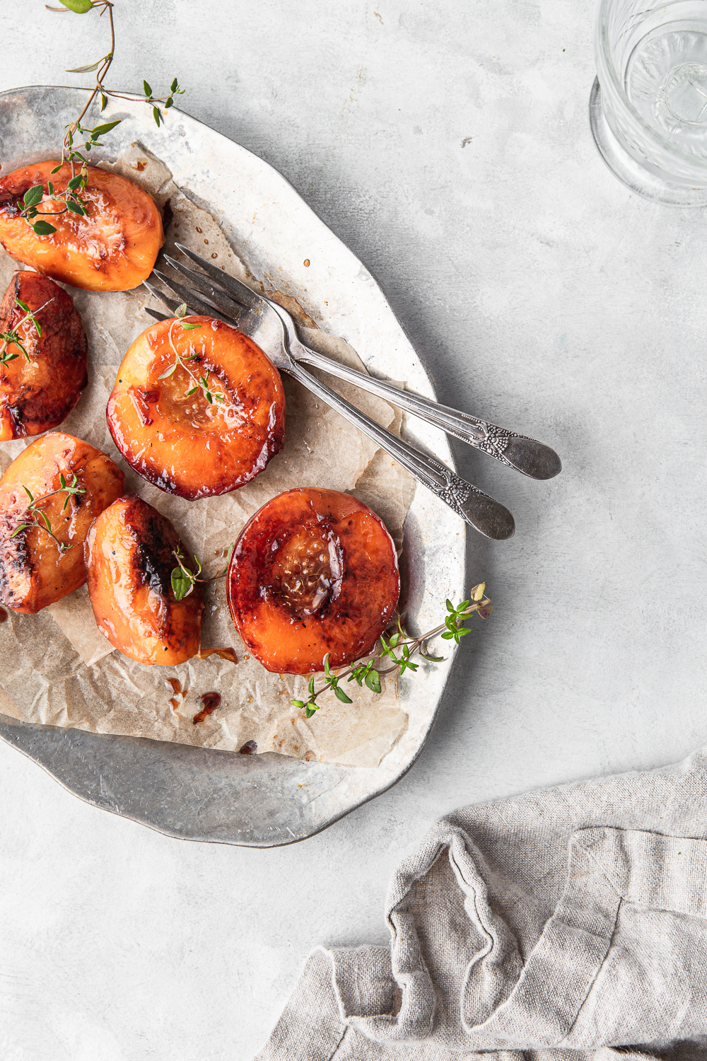 maple glazed peaches on a platter with thyme photography