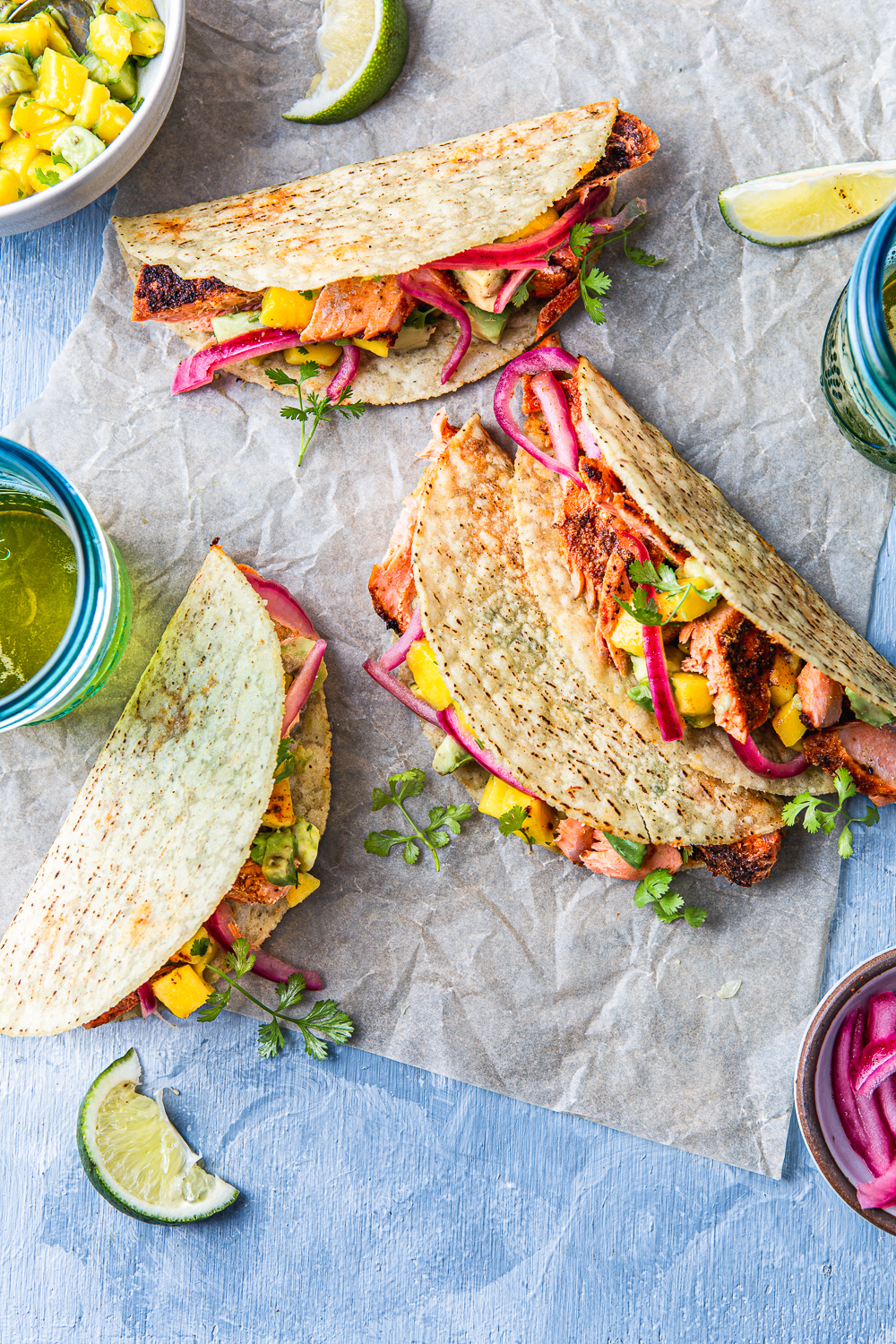 fish tacos with avocado mango salsa on a parchment paper photography