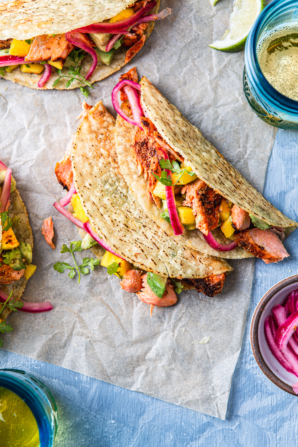 ish tacos with avocado mango salsa on a parchment paper photography