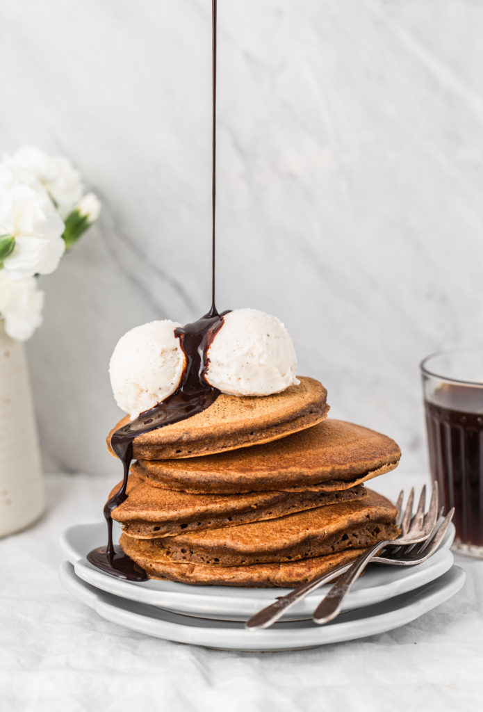 fluffy pancake stack with ice cream and chocolate syrup drizzle