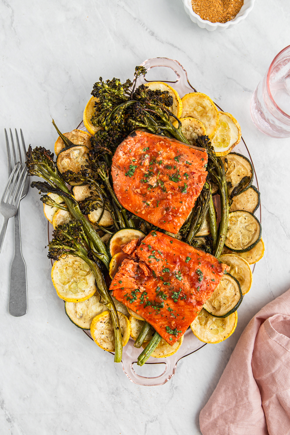 baked salmon over vegetables on a plater photography