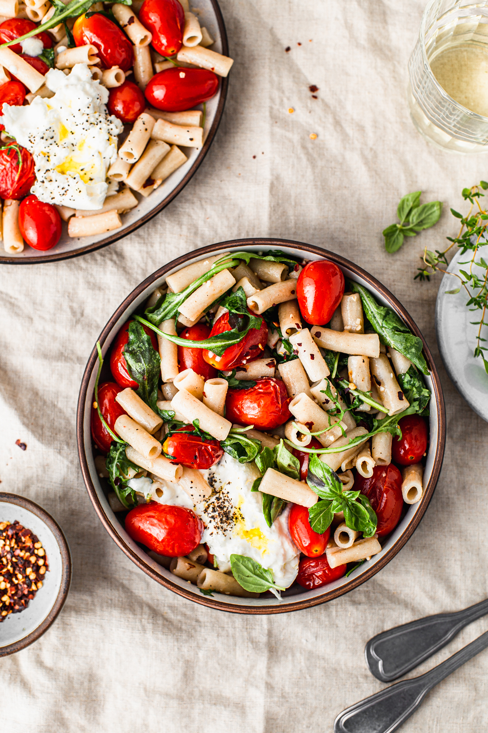 bowls of pasta with cherry tomatoes, herbs and burrata cheese photography