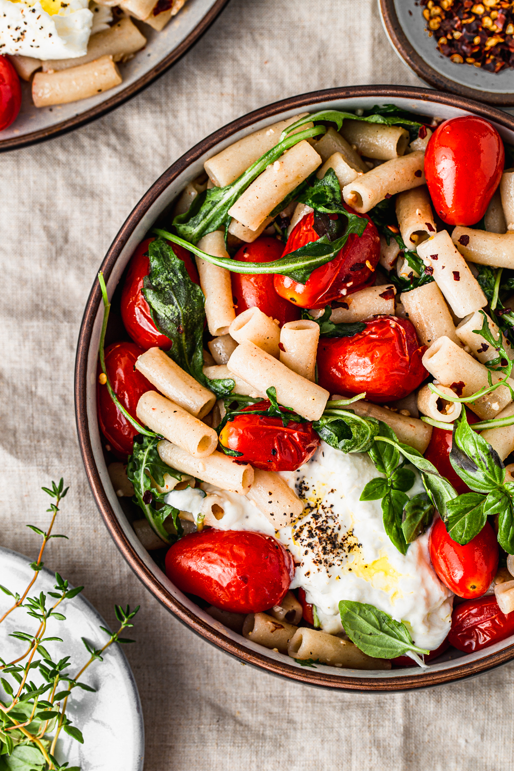 pasta with cherry tomatoes, arugula and burrata cheese photography