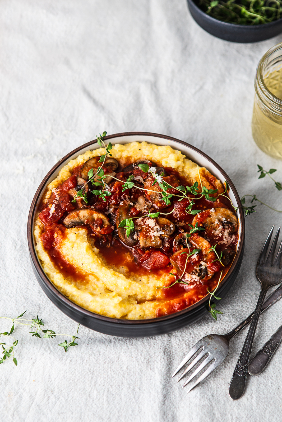 bowl of polenta with mushrooms and tomatoes