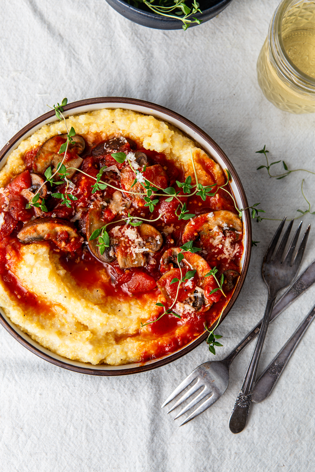 bowl of polenta with tomatoes and mushroom