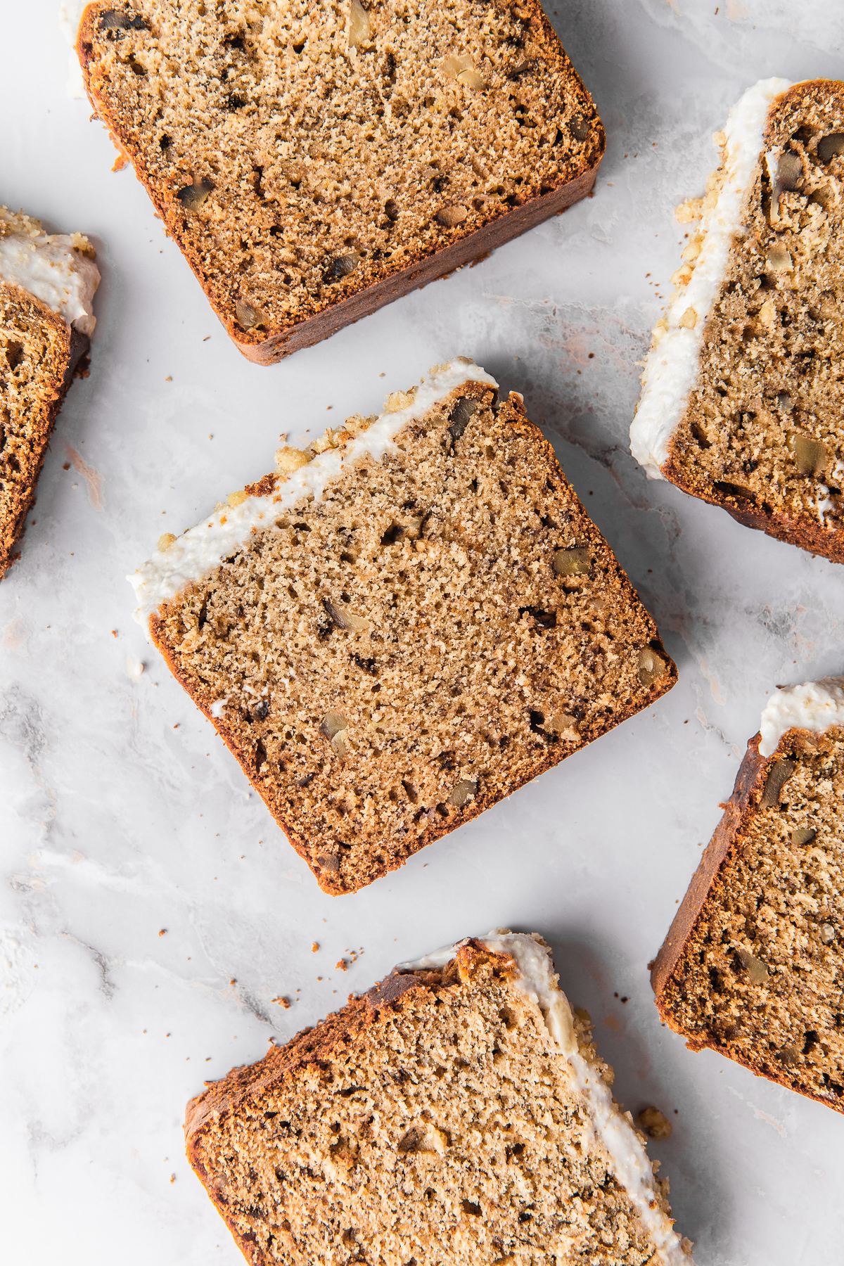 slices of banana bread with frosting food photography
