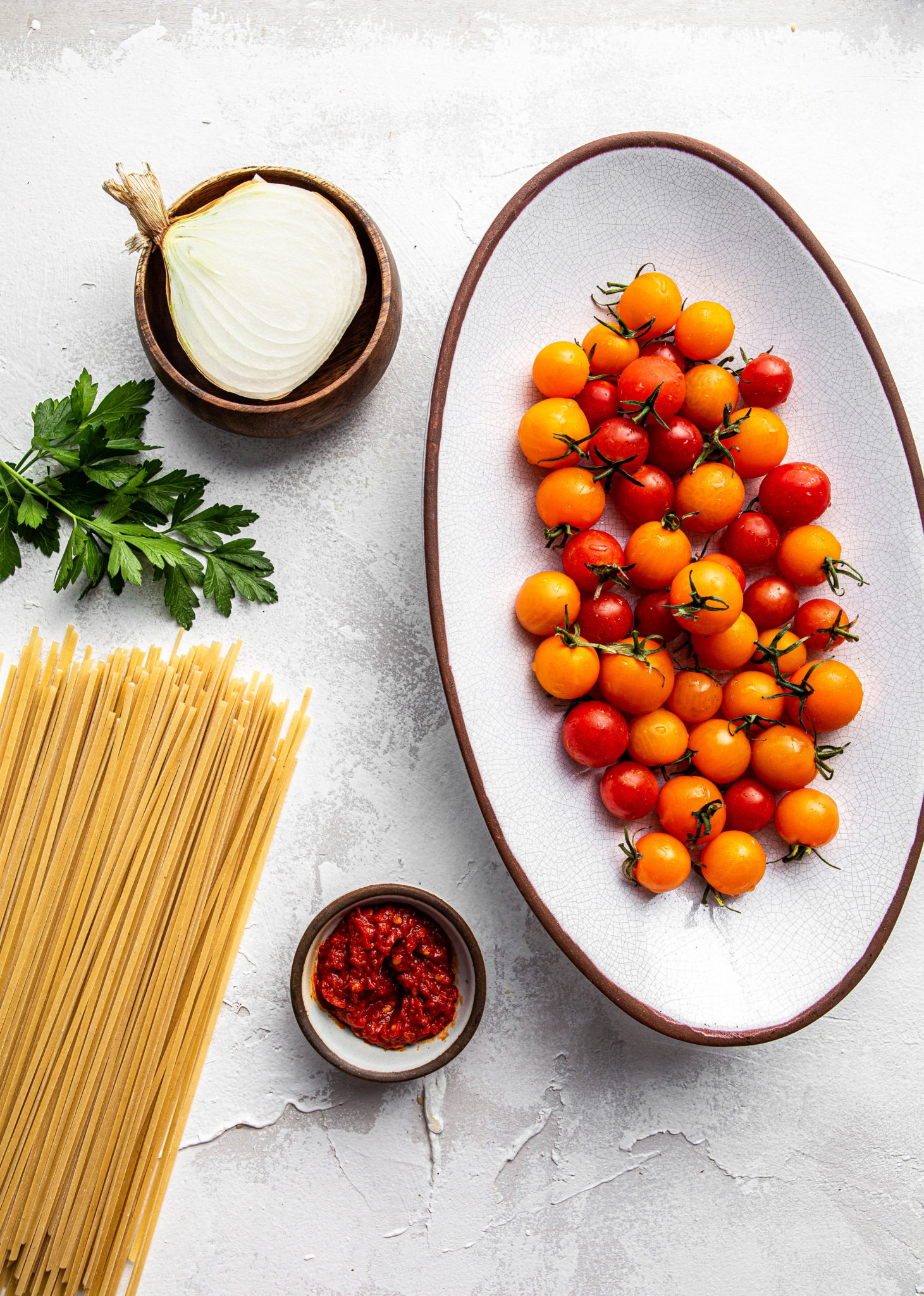 ingredients for fettuccine Pasta with Harissa and Cherry Tomatoes and parsley
