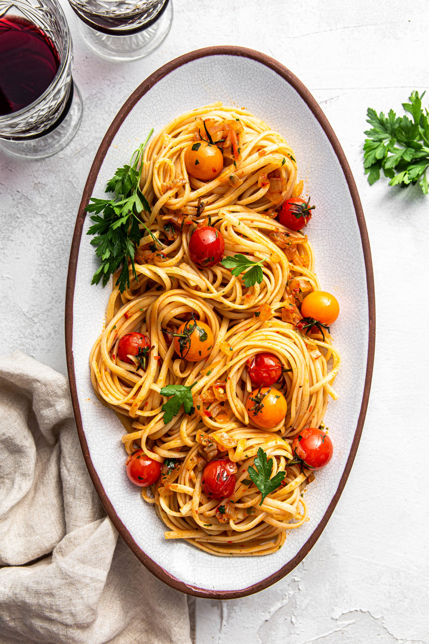 pasta plate with cherry tomatoes and parsley with red wine