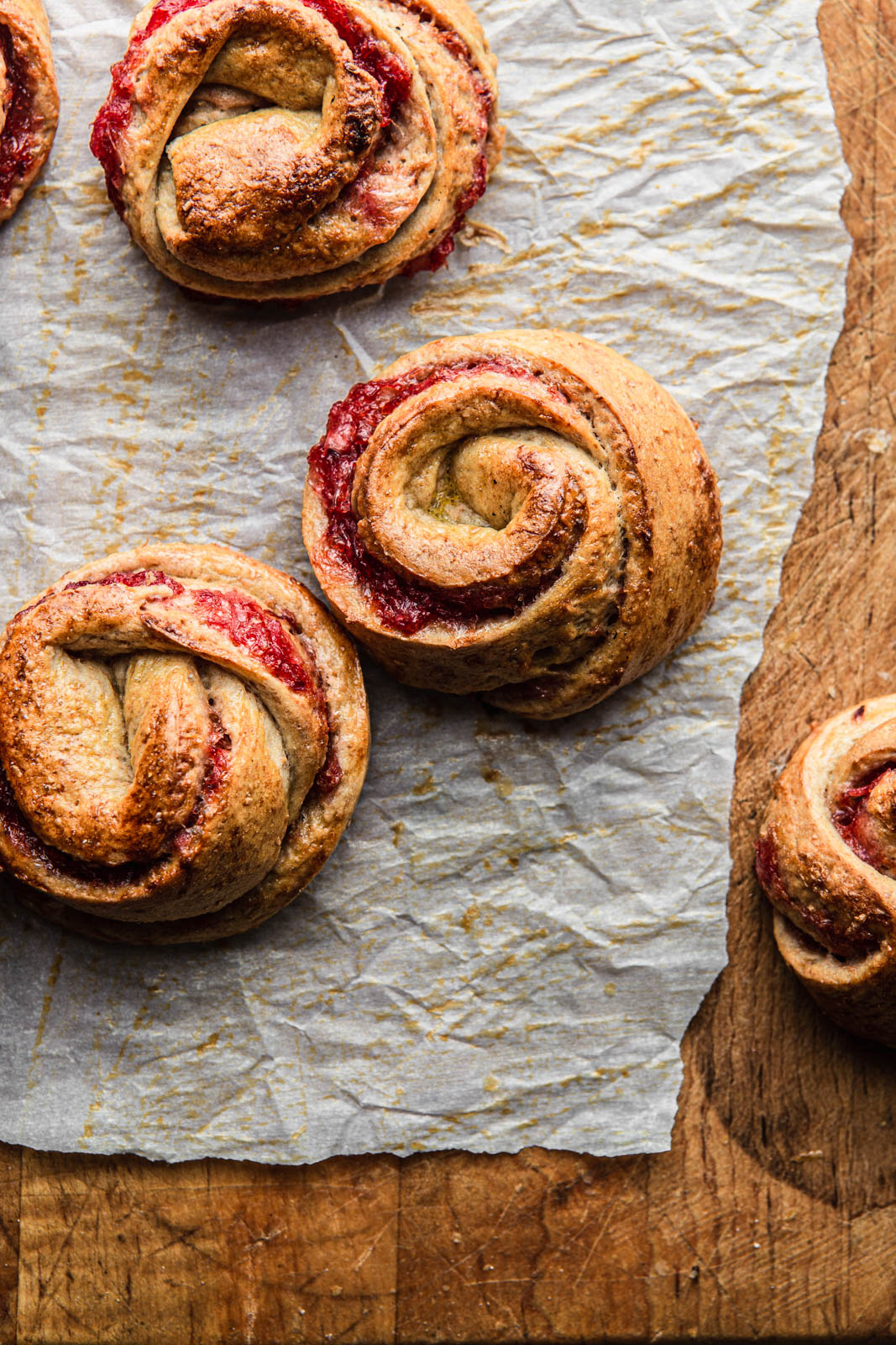 sweet yeast rolls with jam on a parchment paper photography