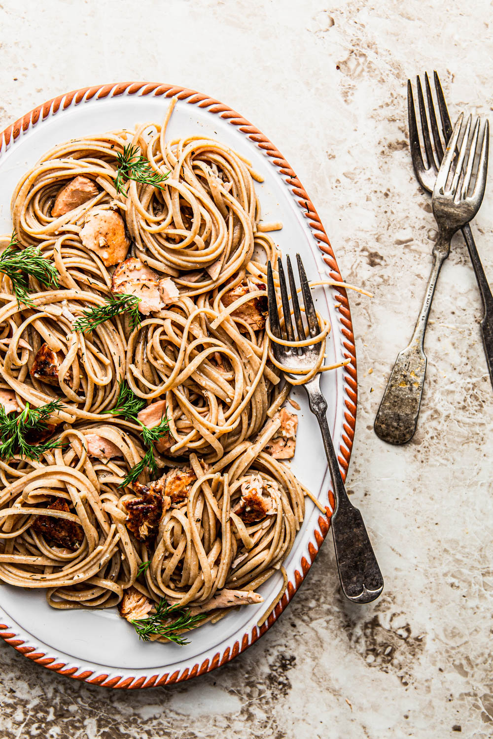 Linguine Pasta with salmon and dill on and oval platter food styling 