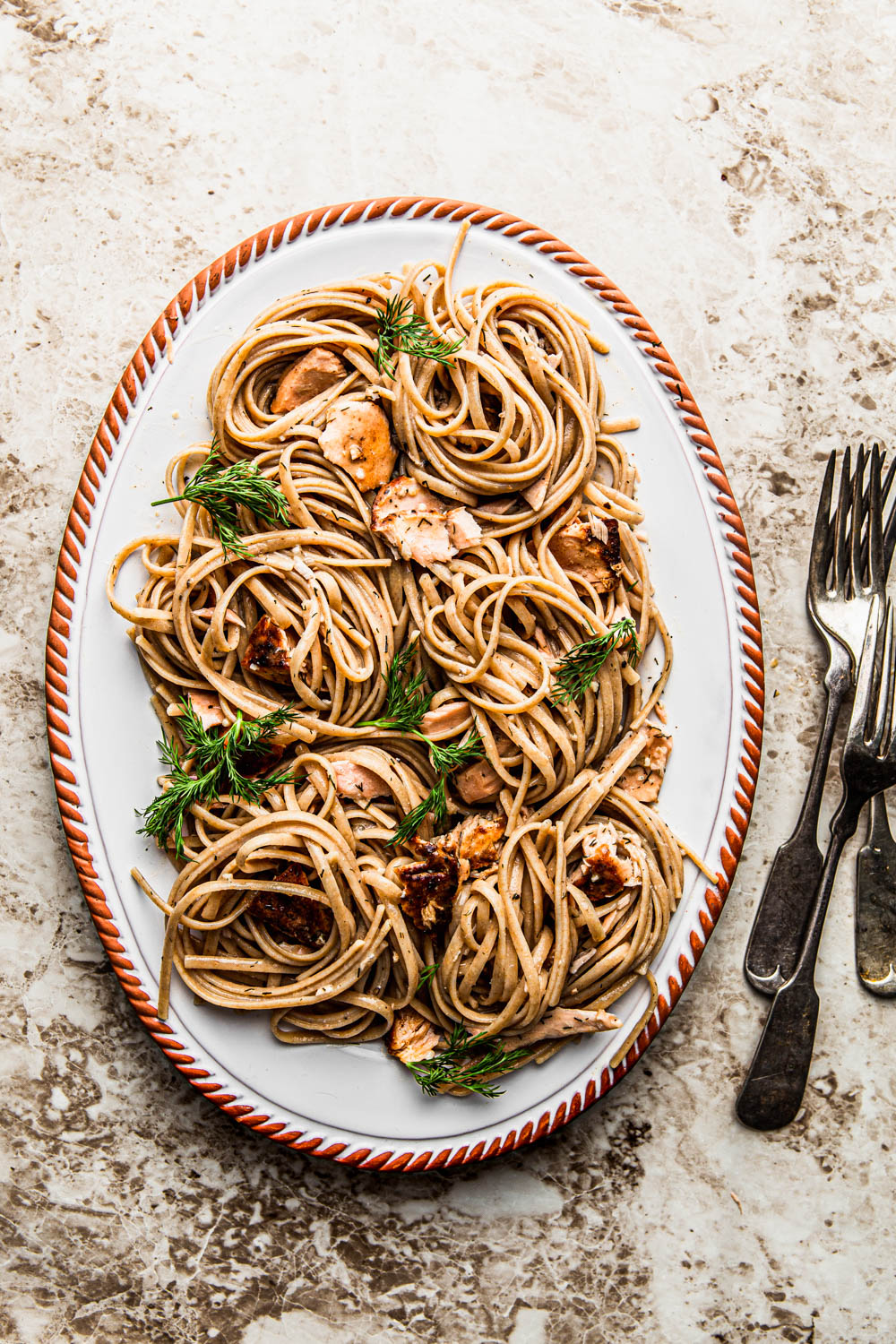 Creamy Salmon Linguine Pasta with dill on an oval platter food styling food photography