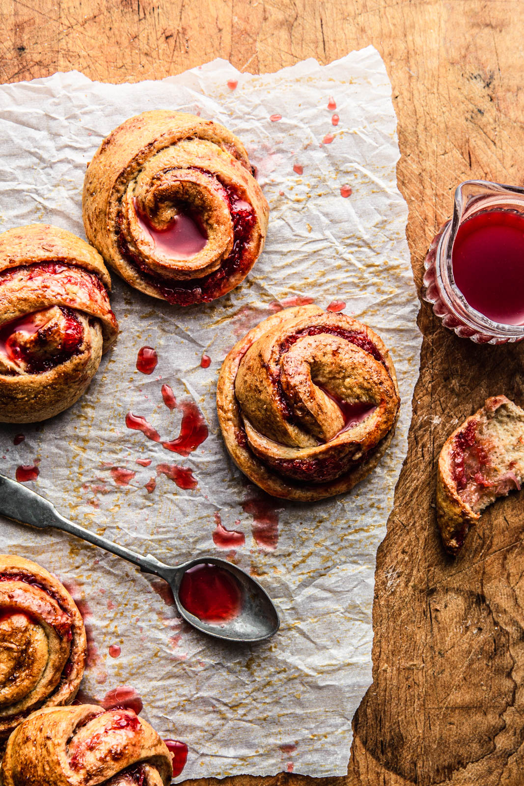Whole Wheat Morning Buns with Blood Orange Jam on a parchment paper foo photography