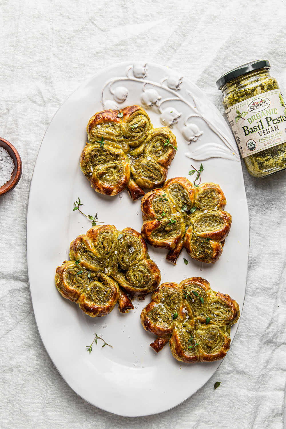 Pesto Puff Pastry Shamrocks on an oval plate with vegan pesto from sprouts