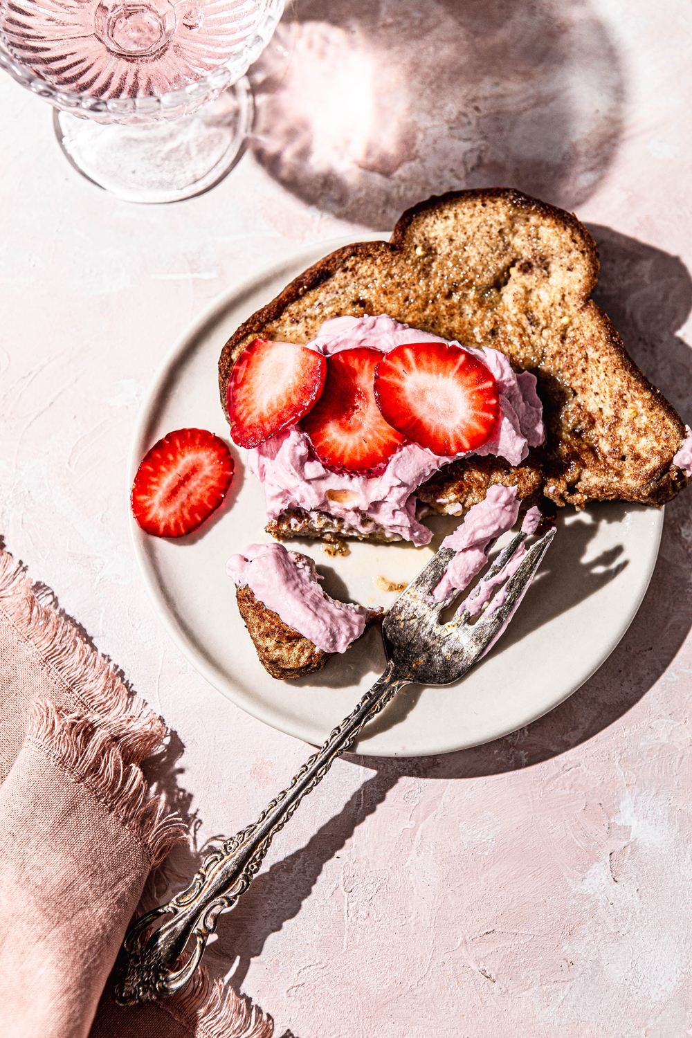 french toast with pink whipped cream and strawberries photography