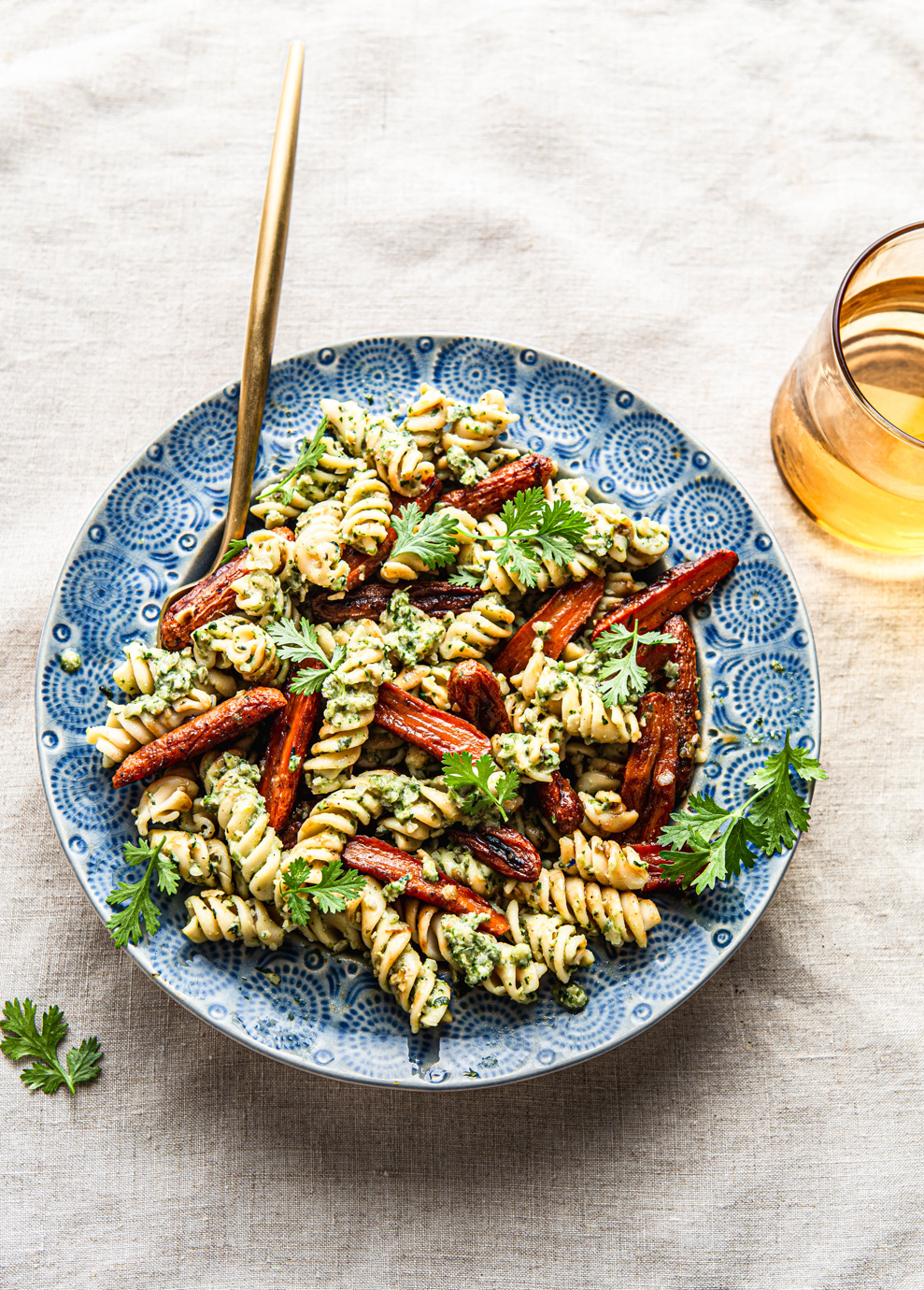 pesto pasta with roasted baby carrots and cilantro food photography